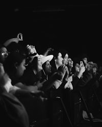 a black and white photo of a crowd at a concert