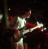 a man playing a bass in front of a crowd